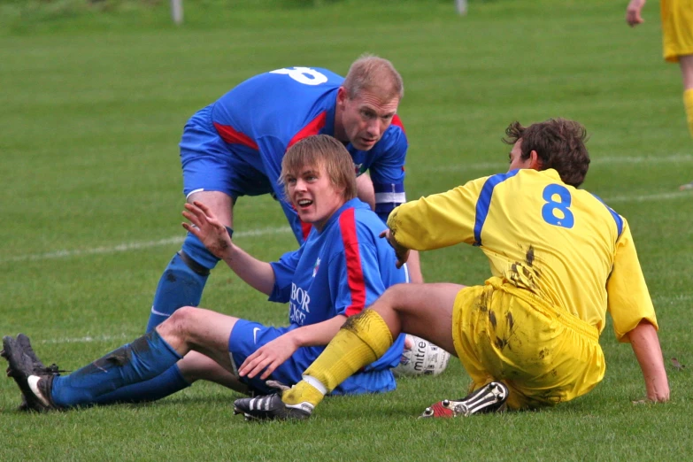 a group of men in uniforms playing soccer