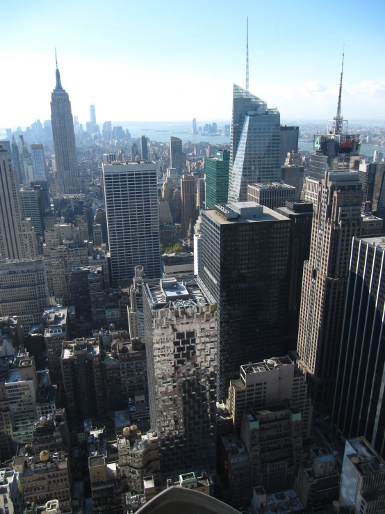 the view from the top of the building looking down on a city with skyscrs and skyscrs