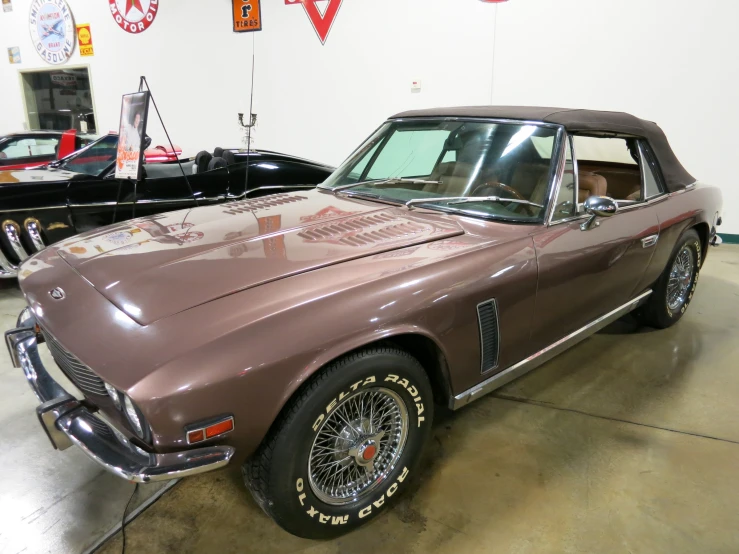 this very old brown car is sitting in a garage