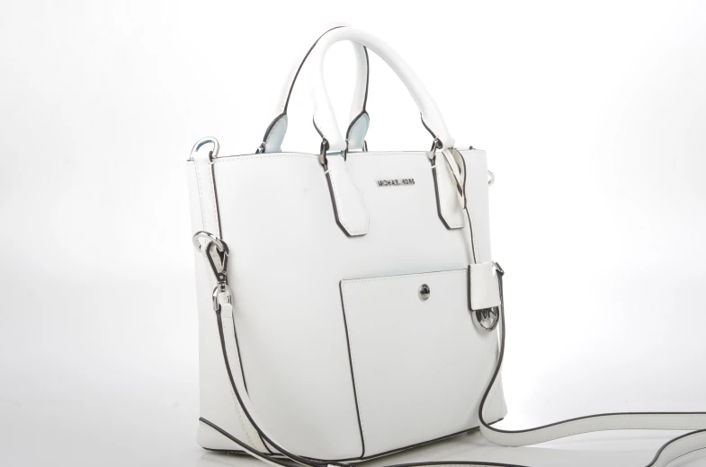 a white purse with strap in front of it