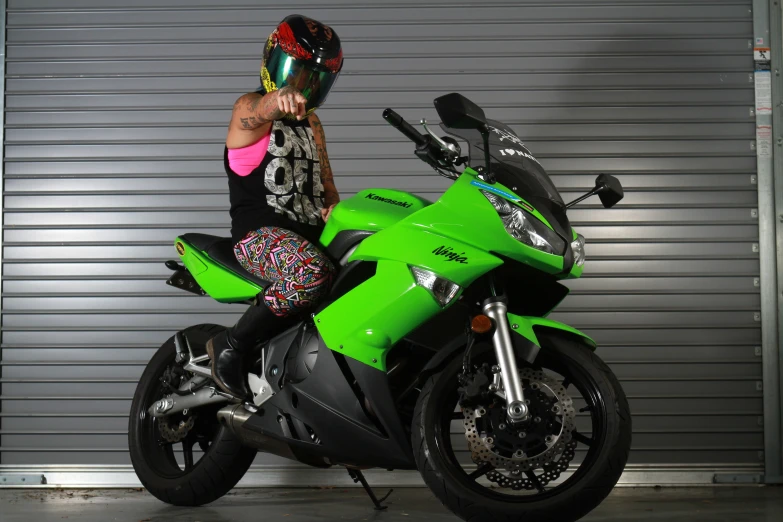 a female is standing by her motorcycle