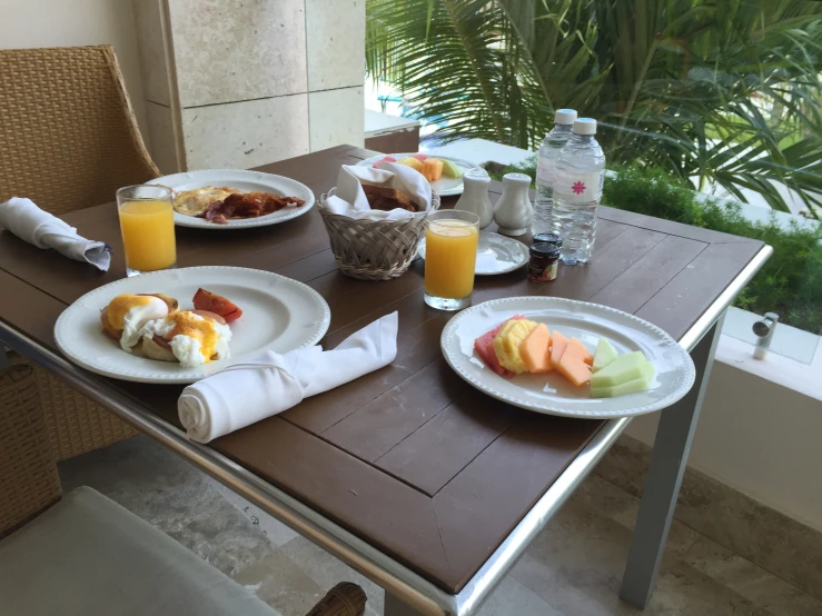 a table topped with a meal of fruit and coffee