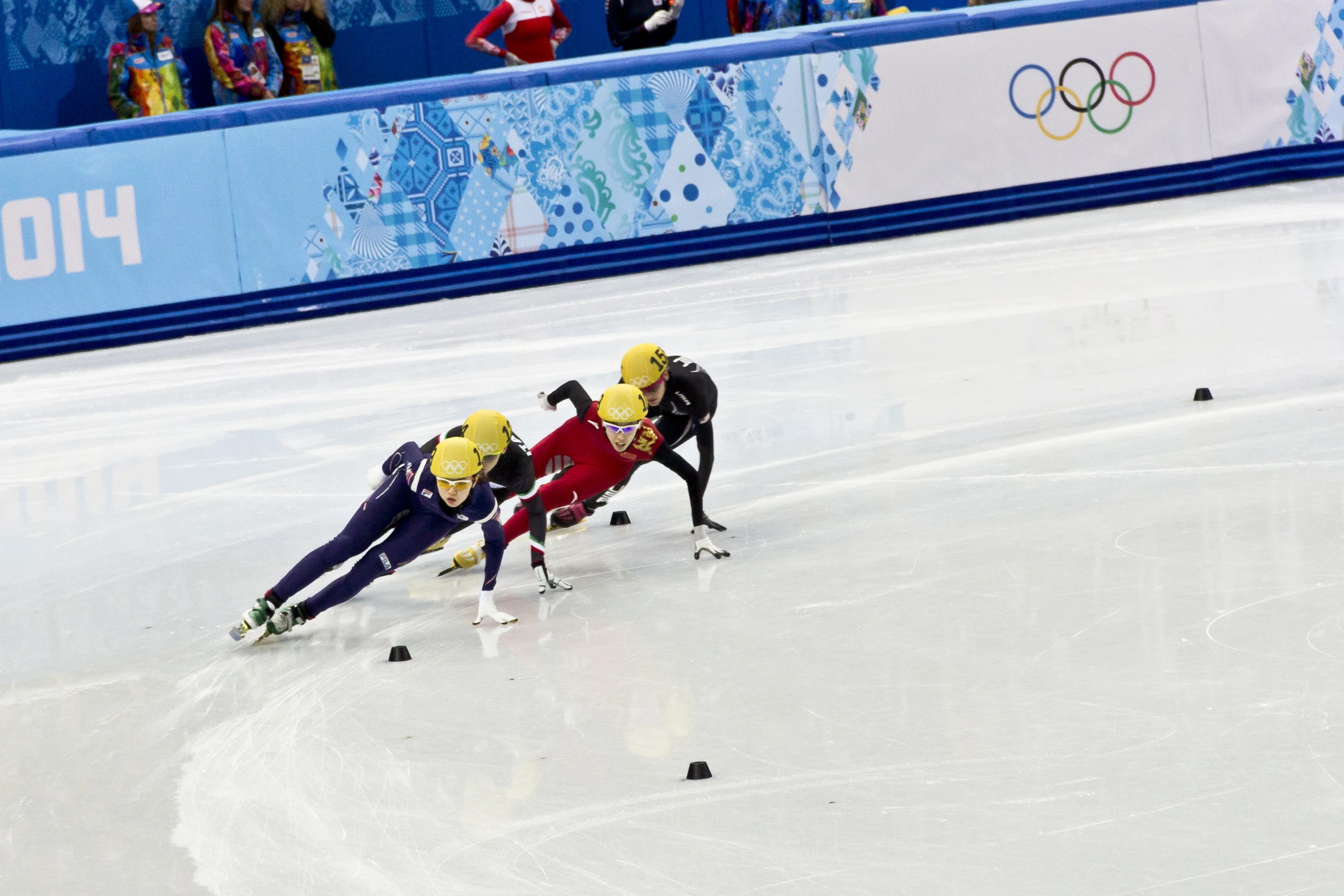 two ice skating competitors hing each other along the track