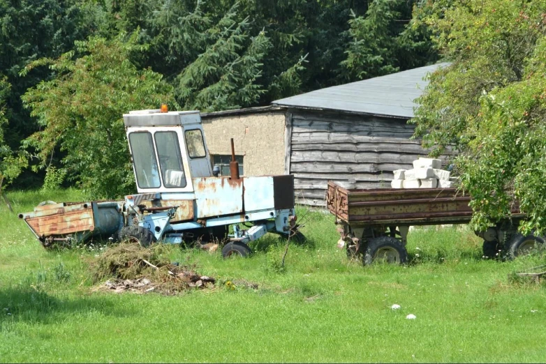 an old dump truck parked in a yard