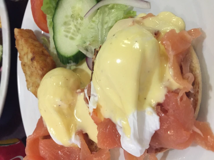 two plates with food, one is open faced and the other has salad