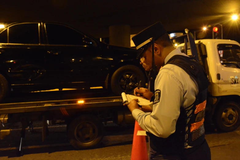 a person with a cell phone next to a truck