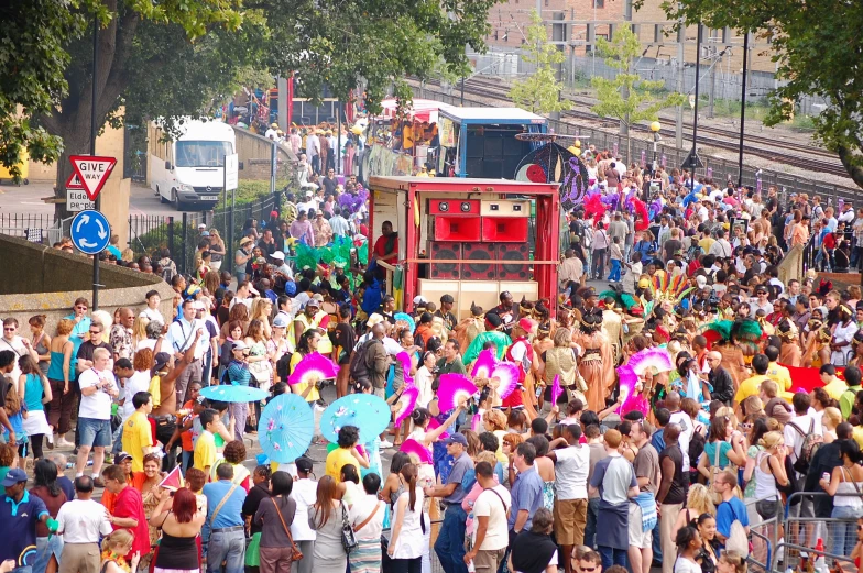 many people are walking down the street and a bus