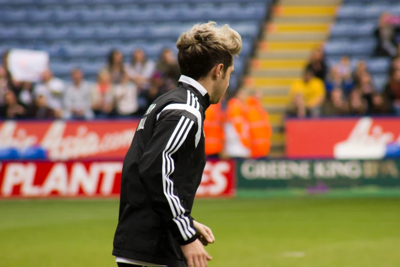 a male soccer player in black shirt and white pants