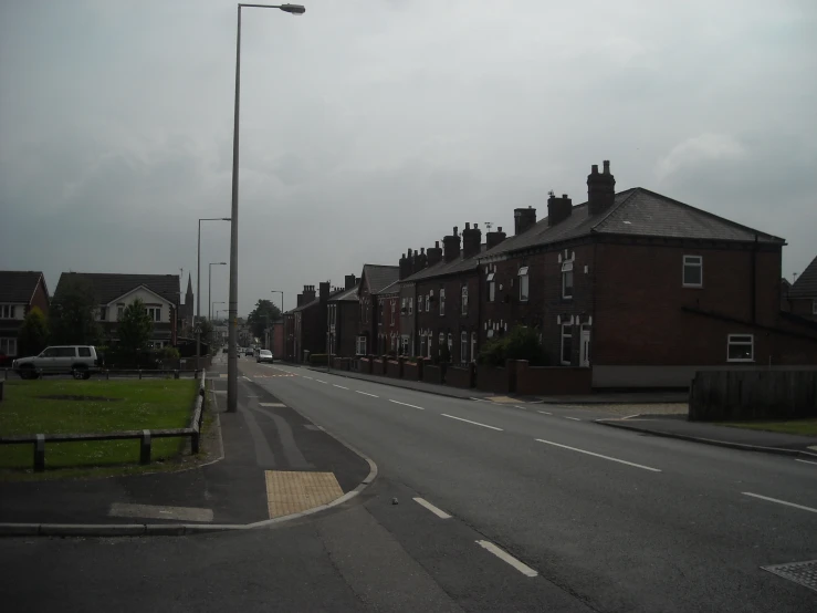 street with buildings on both sides and cars parked on side