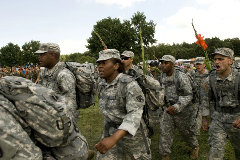 a group of men wearing army uniforms standing in a line