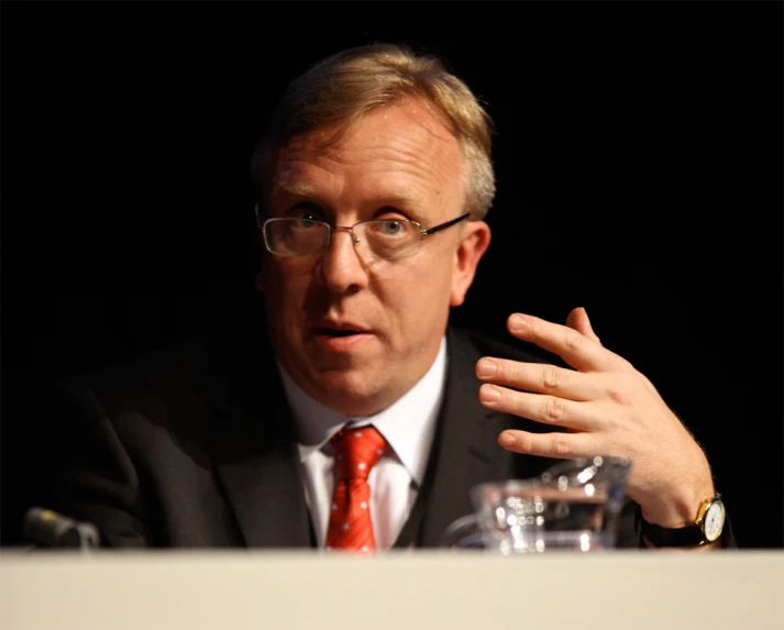 a man wearing glasses and a suit