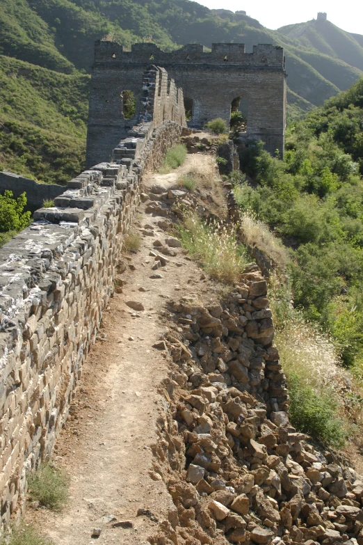 the large brick wall along the side of the road