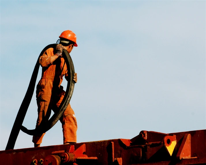 a person with a hose on a steel rail