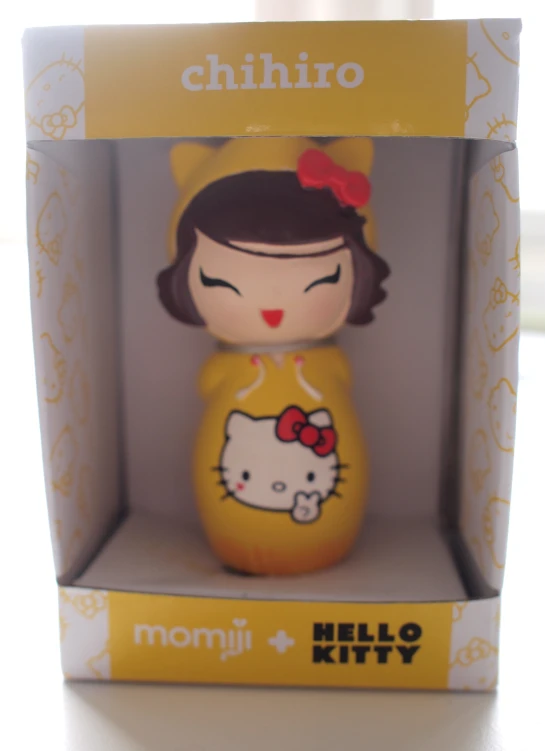 a plastic hello kitty doll with a bow