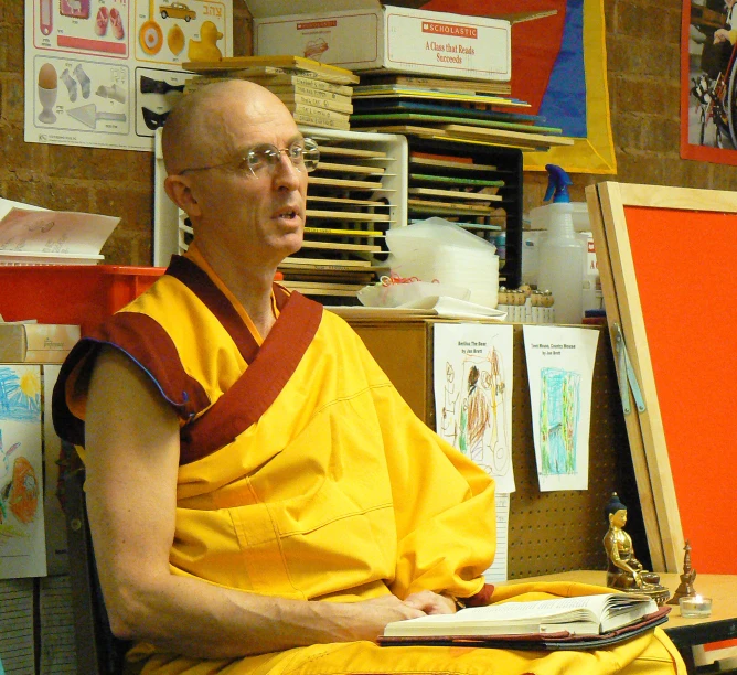 a man sits in front of a wooden easel