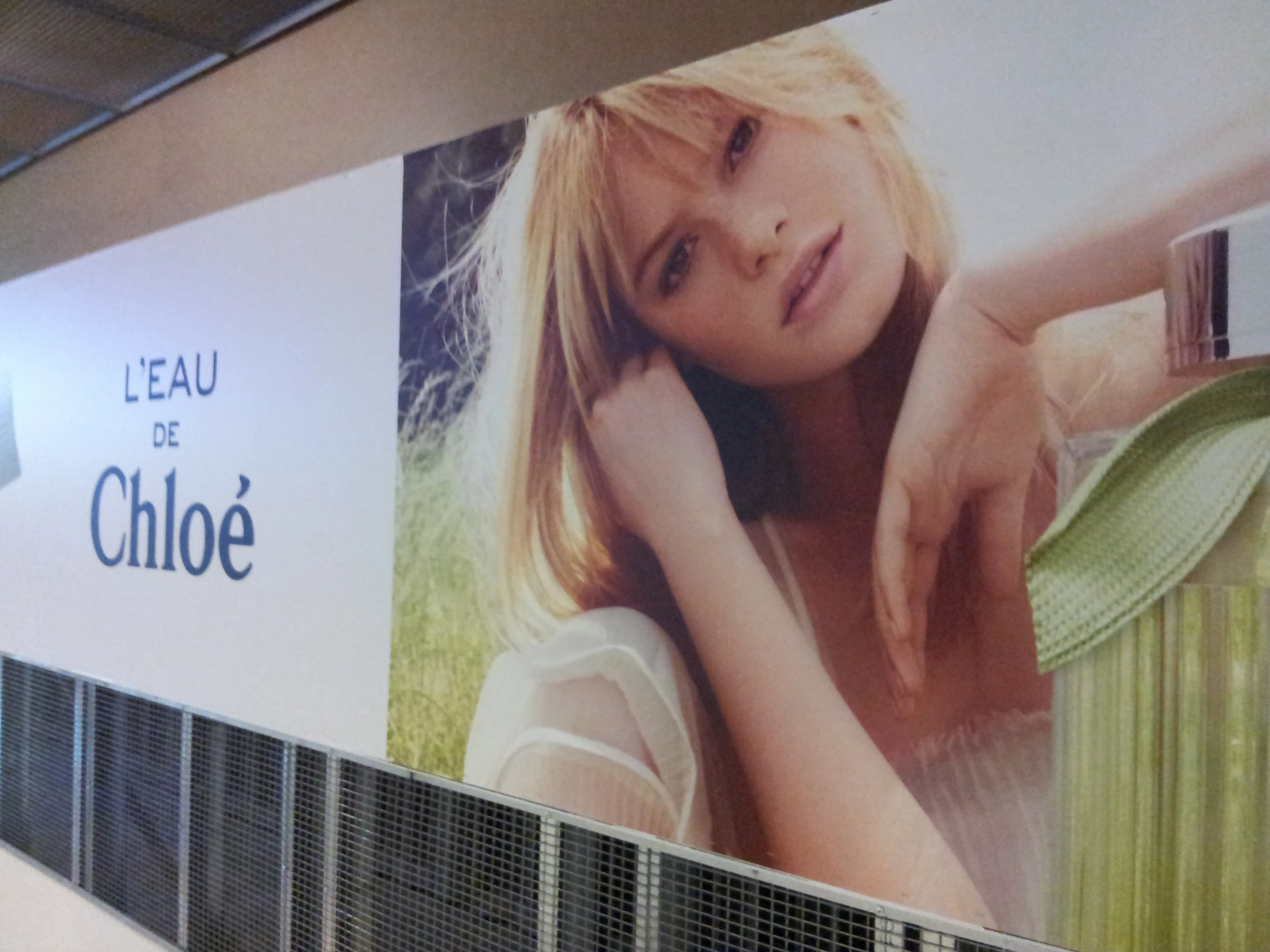 a large wall has advertits for beauty stores