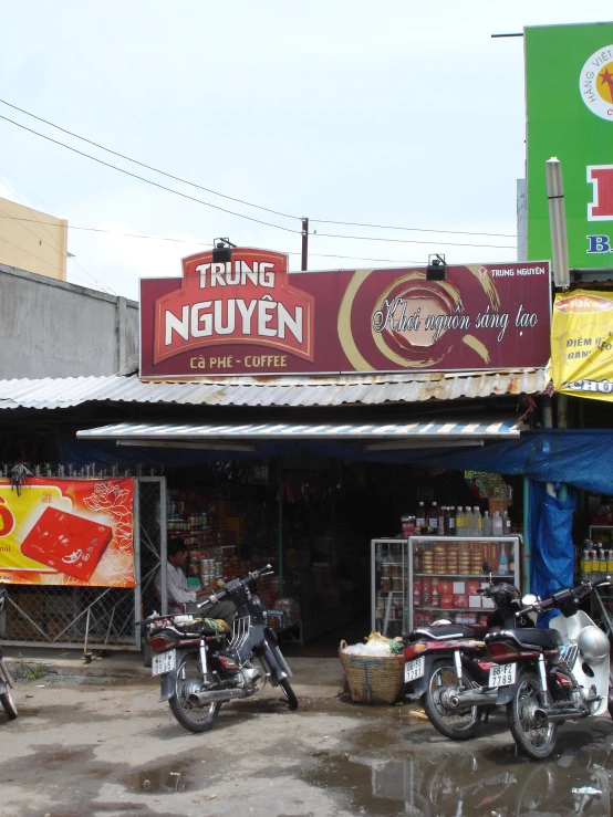 several motorcycles are parked outside a cafe called