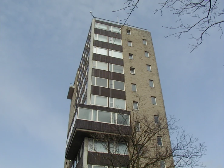 a tall brown building with balconies on the side