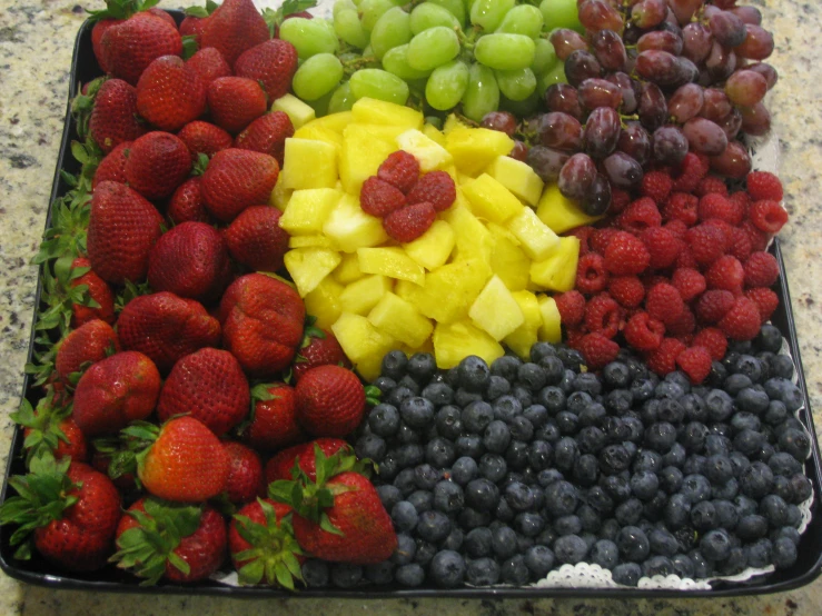 a tray filled with lots of different fruits