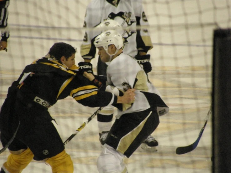 several people on a rink playing ice hockey