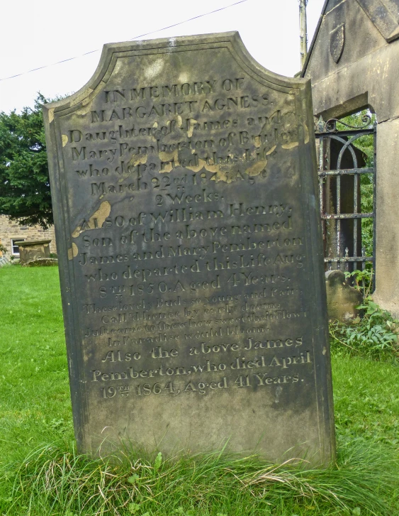 an old stone plaque is in the grass