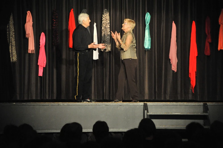 an image of a person and woman on stage