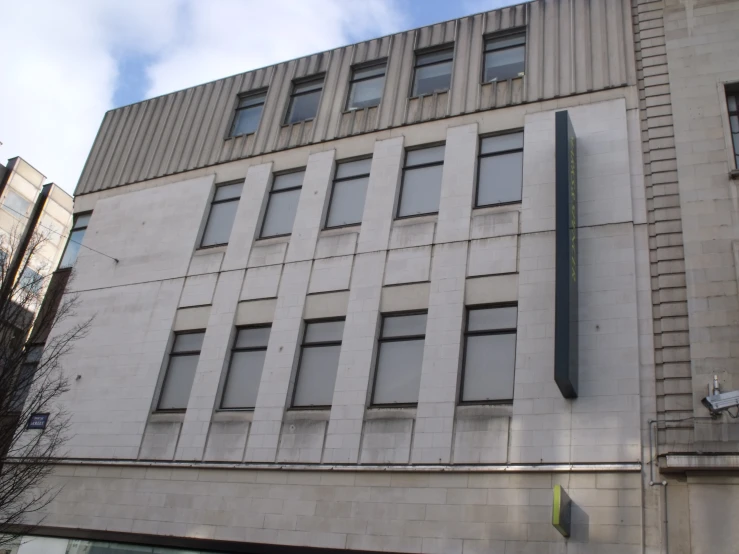 a large white brick building with some windows