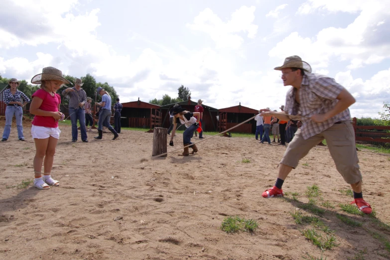 a group of people watching a dog throw a baseball