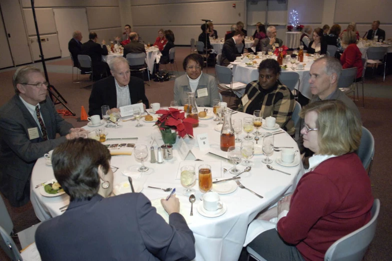 there are many people that are sitting at a table together