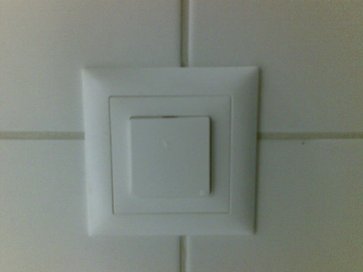 a white electrical outlet attached to the side of a wall
