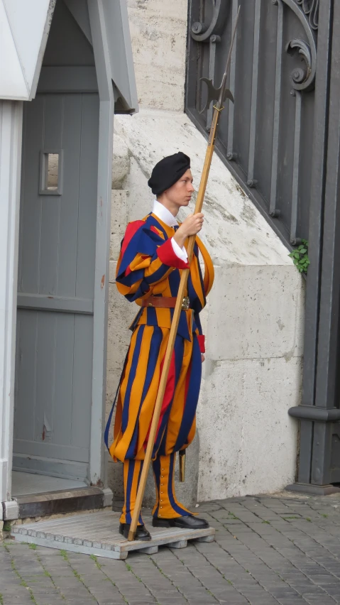 a person wearing an elaborate outfit and holding a broom