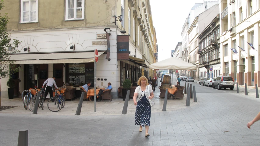 a lady that is walking on some bricks