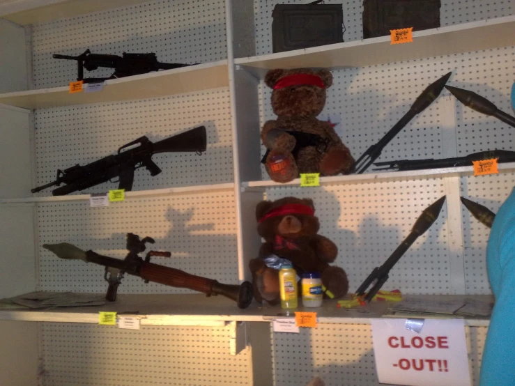 several shelves filled with guns and stuffed toys