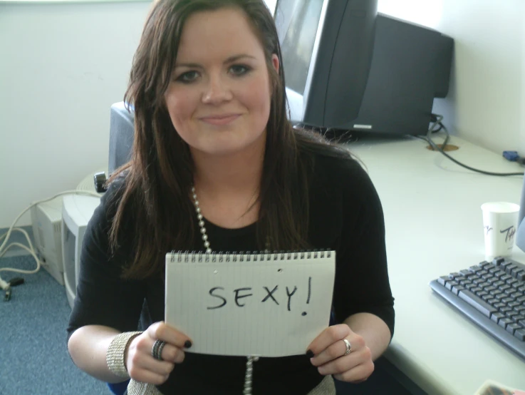 a woman holding a sign with the word 