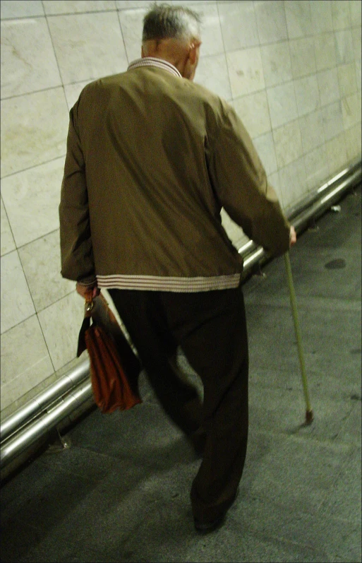 a man in a coat walking on a walkway