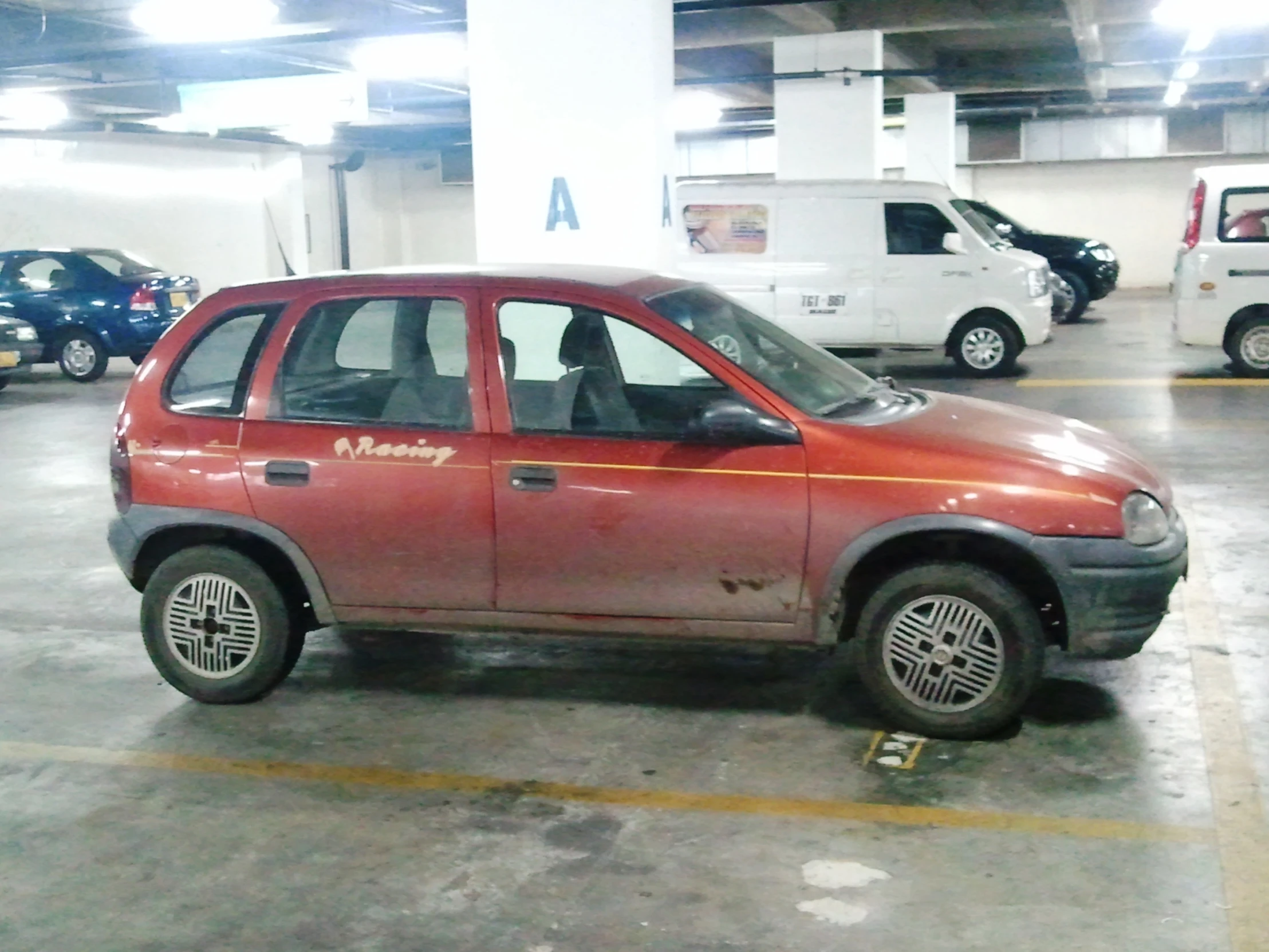 an abandoned car is parked in a parking garage