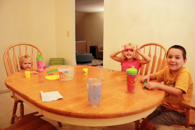 two young children sitting at a table together