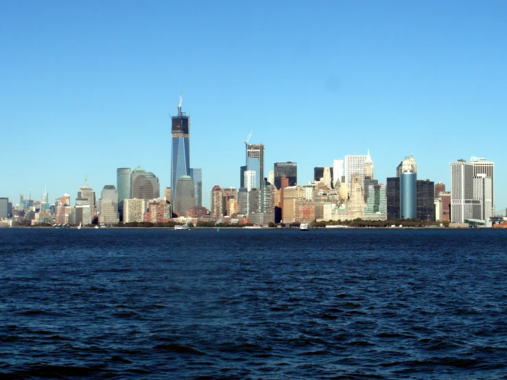 a tall city with the skyscrs of new york as seen from across the water