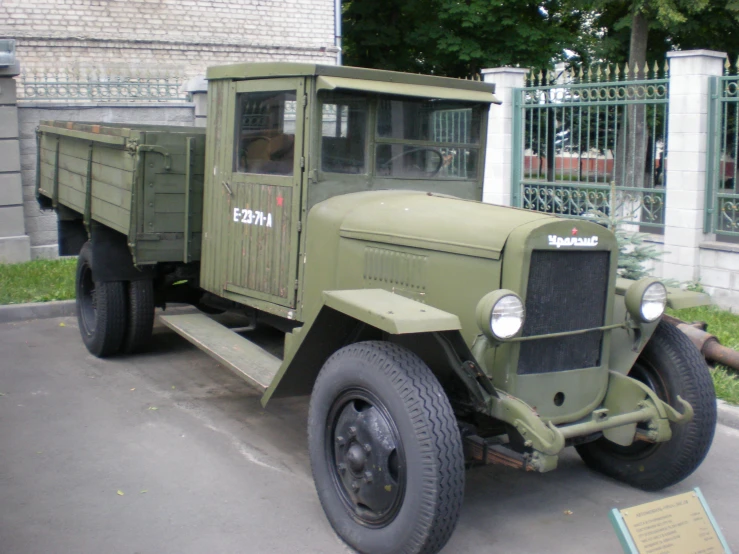 an old military truck parked in front of a building