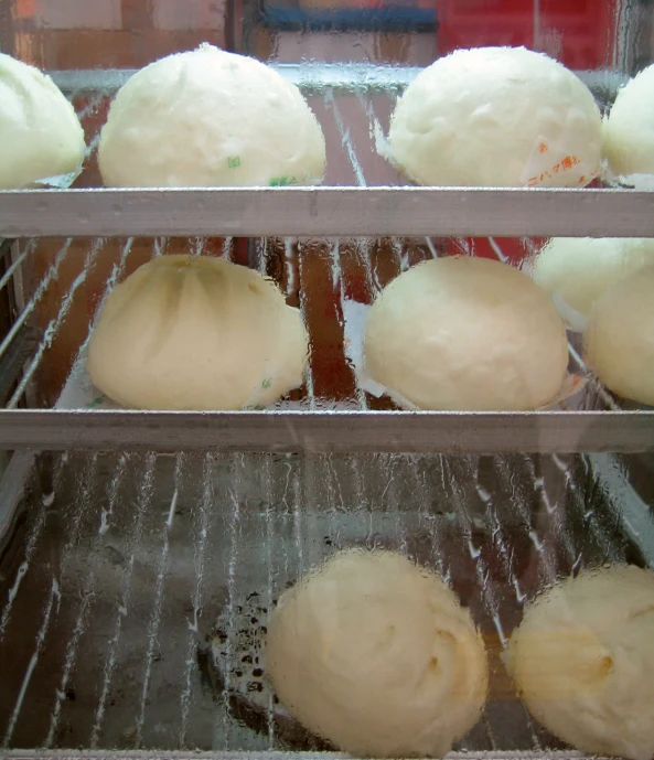 freshly baked buns in a glass display case