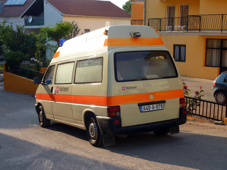a van parked on the street near a house