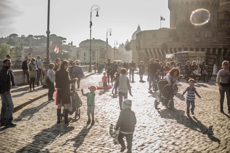 several people walking down a cobblestone road