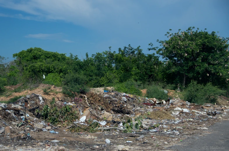 a lot of trash sitting next to the side of a road