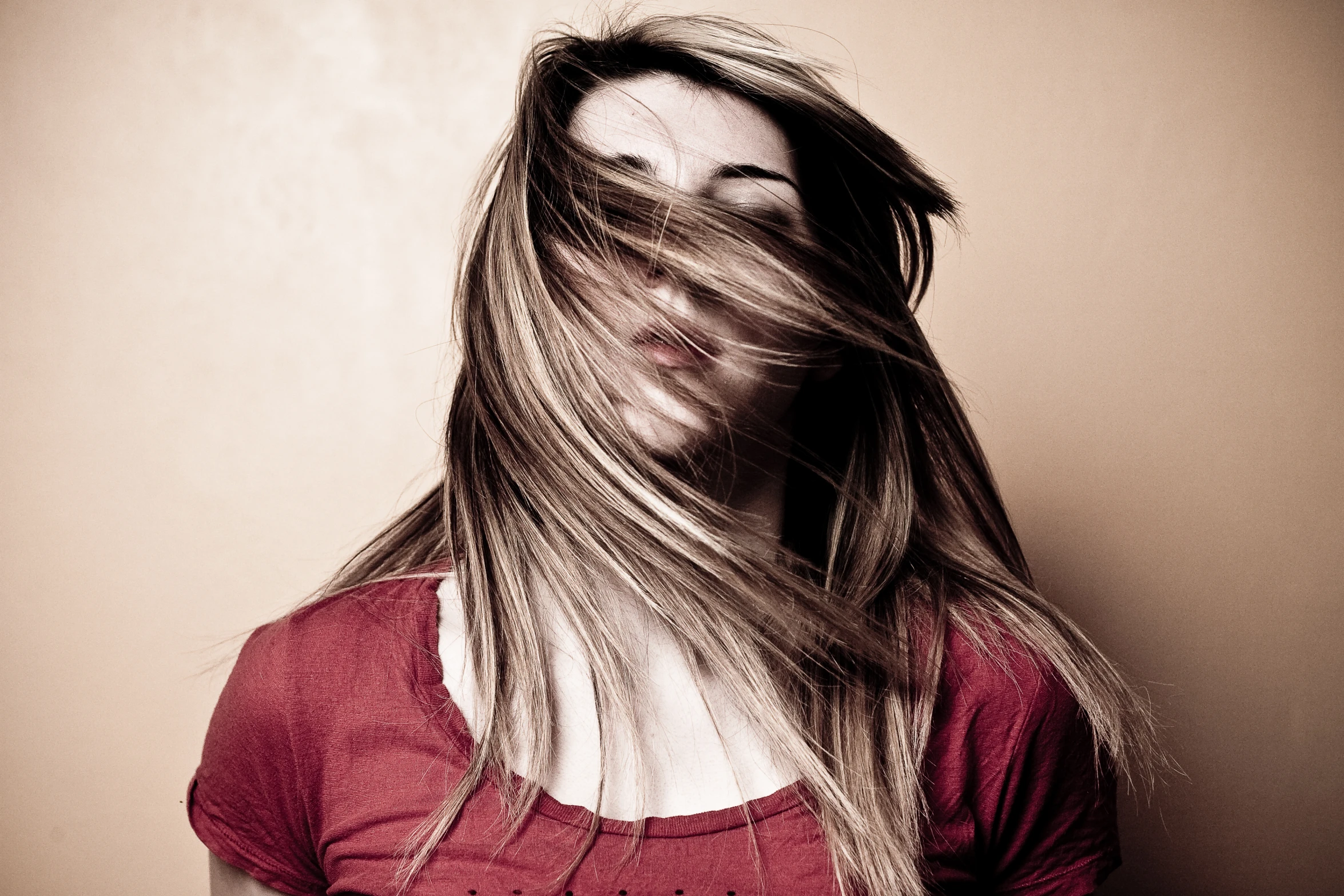 a young woman is posing with her long hair