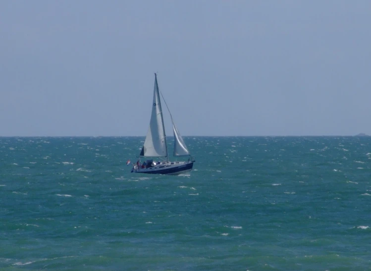 a sailboat in the middle of the ocean