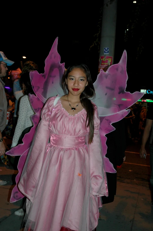 a woman in a pink fairy costume