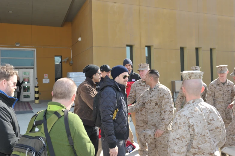 the people are having a conversation outside near the building