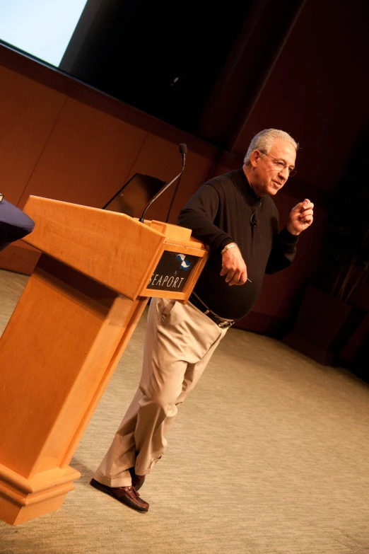 man at podium giving speech during lecture