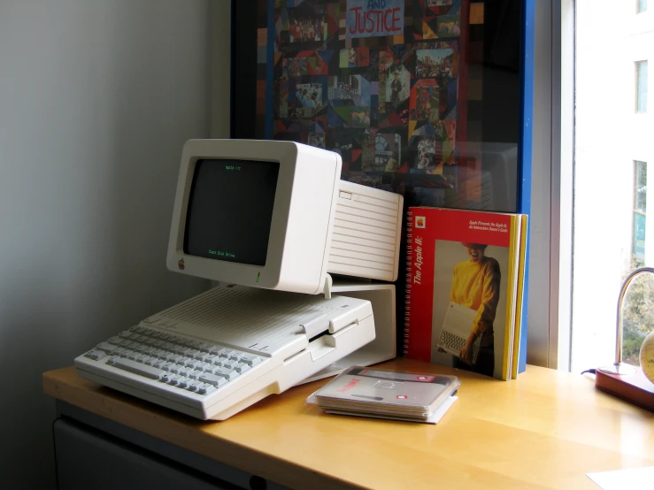 a small desktop computer and an electronic device on a table