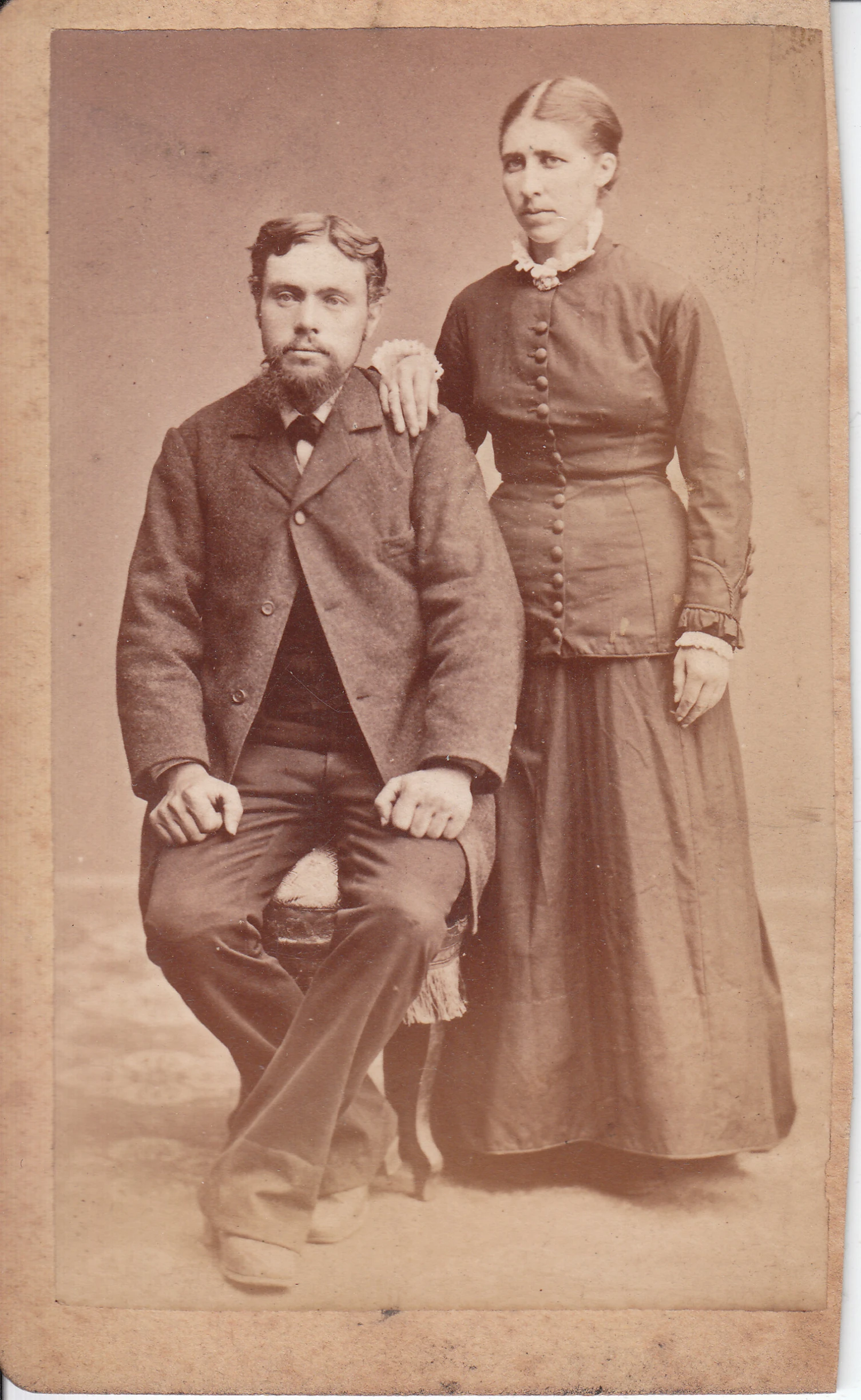 two old fashioned people dressed in costumes and posing for a picture